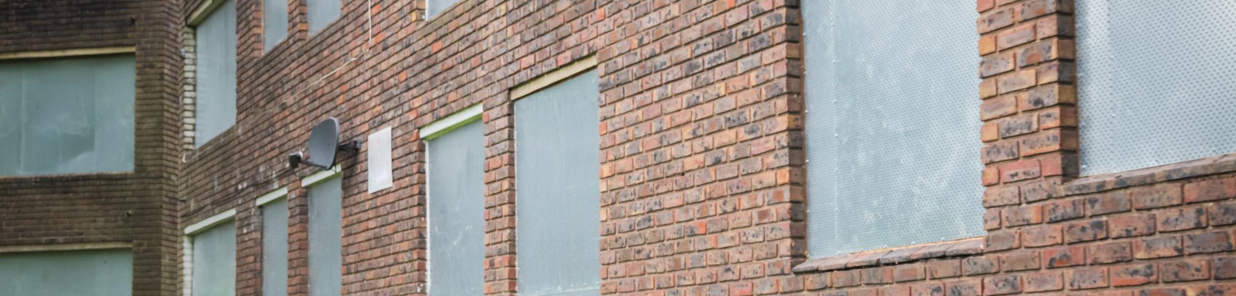 Secured windows at a vacant property requiring professional security